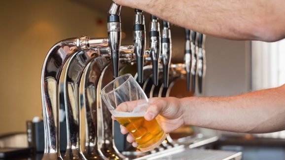 bigstock-Mans-hand-pouring-pint-of-beer-50551841