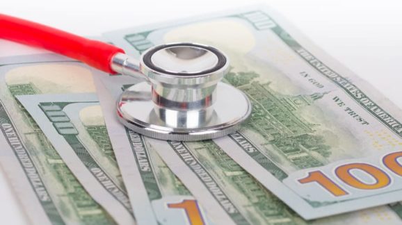 Stethoscope and cash GettyImages-1093503104